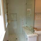 Able Glass installed a heavy glass frameless shower enclosure with brushed nickel clips, hinges, and back-to-back c-pull.  This is a door with inline panel and 90° return.